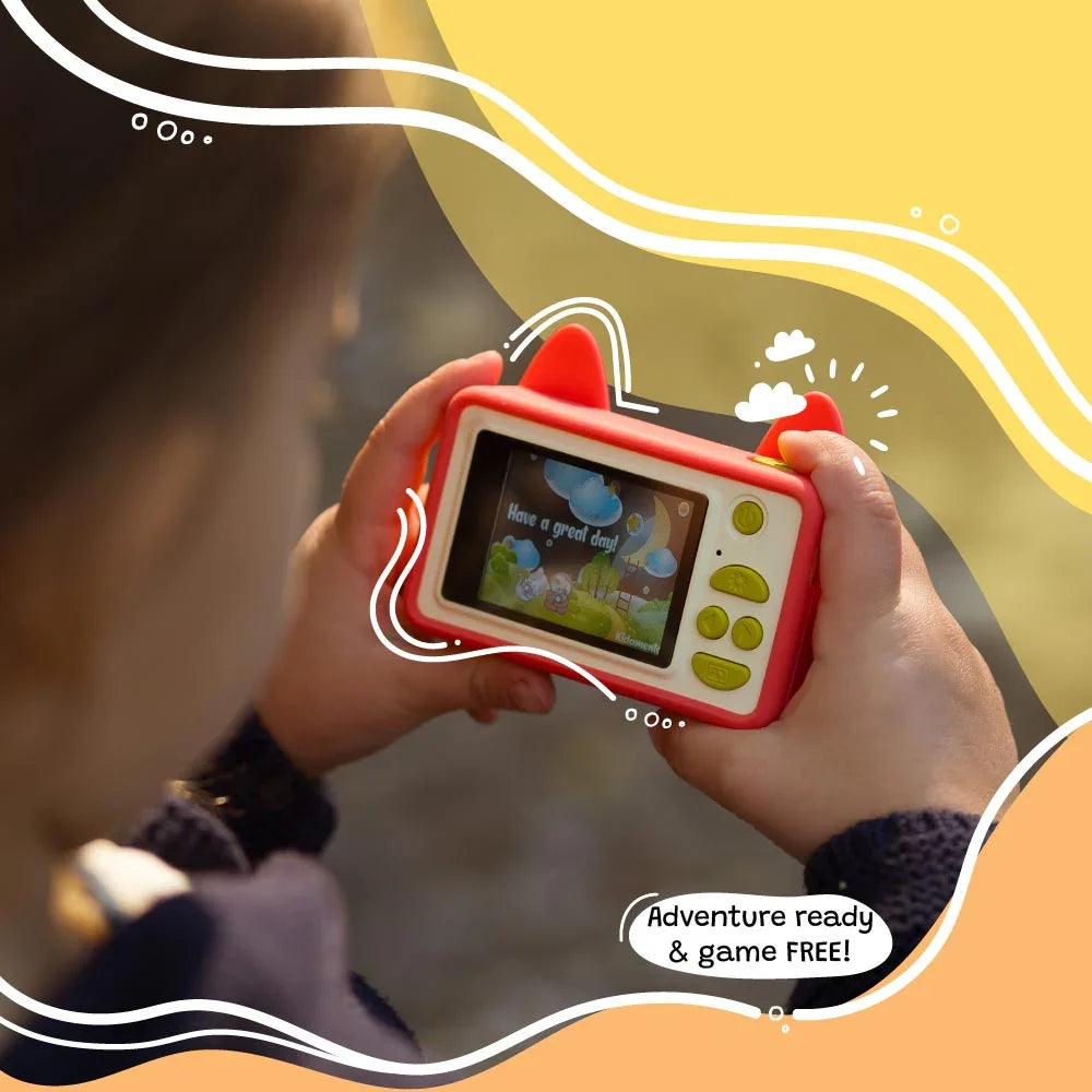 Child holding kiimento Model C Fox camera showing back screen with fun message and kid-friendly buttons