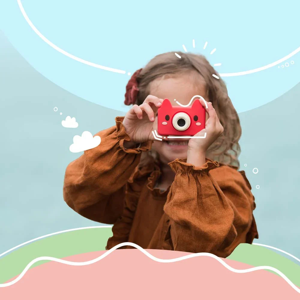Young girl holding kiimento Model C Fox kids camera up to her eyes, ready to take a photo