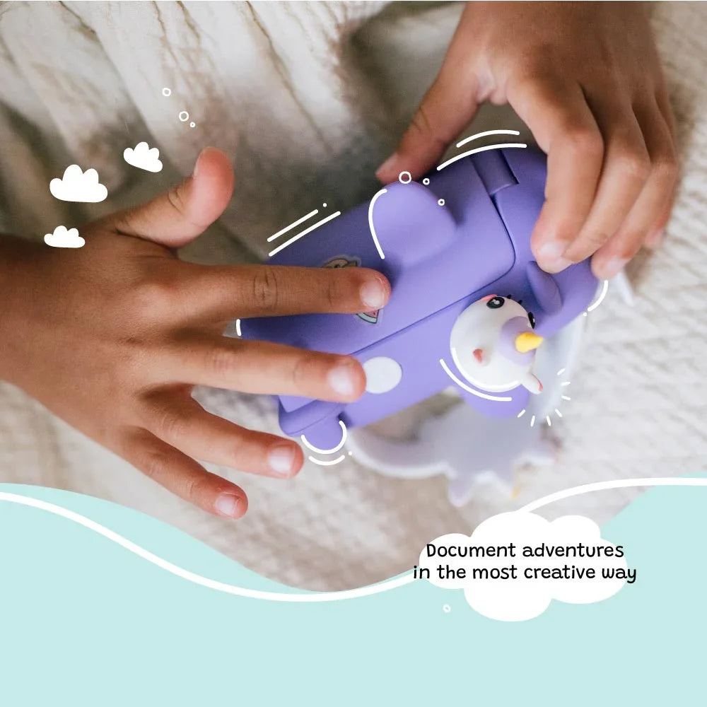 Child’s hands holding the kiimento Model V unicorn kids digital camera. Highlights the purple airplane design with unicorn details—encouraging creative play and storytelling for ages 3 to 9.