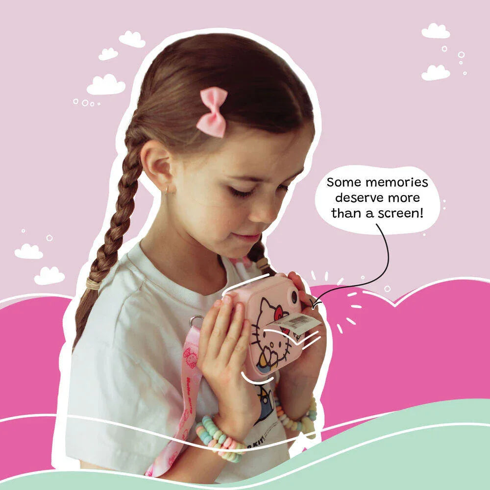 Young girl using the kiimento Hello Kitty Model P kids digital camera to print a photo. The child, wearing pastel accessories and a pink bow, holds the camera close while a black-and-white photo prints out. The background features whimsical clouds and hills, with a caption that reads, “Some memories deserve more than a screen!”