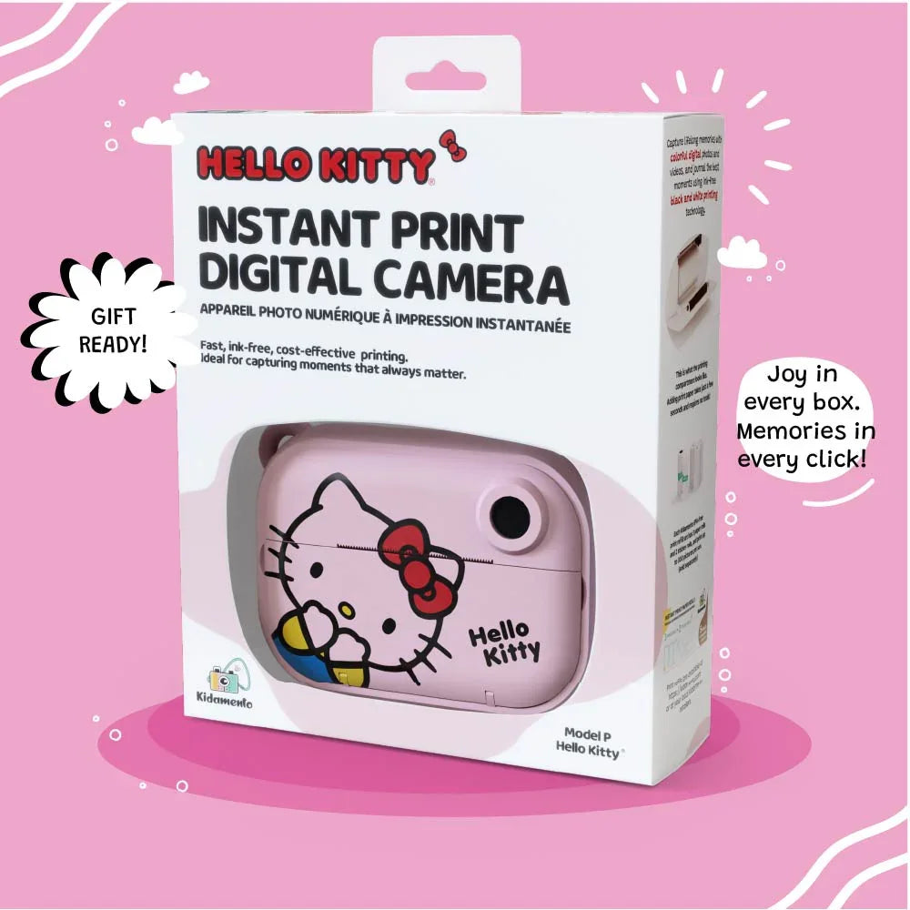 Retail packaging of the kiimento Hello Kitty Model P instant print digital camera, featuring a window showing the pastel pink camera with Hello Kitty’s face. The box highlights gift readiness, ink-free and cost-effective printing, and memory-making appeal. Tagline at the bottom reads: “Joy in every box. Memories in every click!”