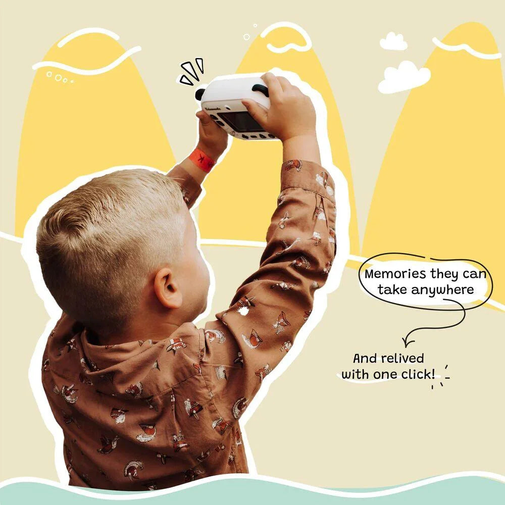 Boy holding up kiimento Model P Panda kids camera, capturing memories outdoors with playful illustrated background.