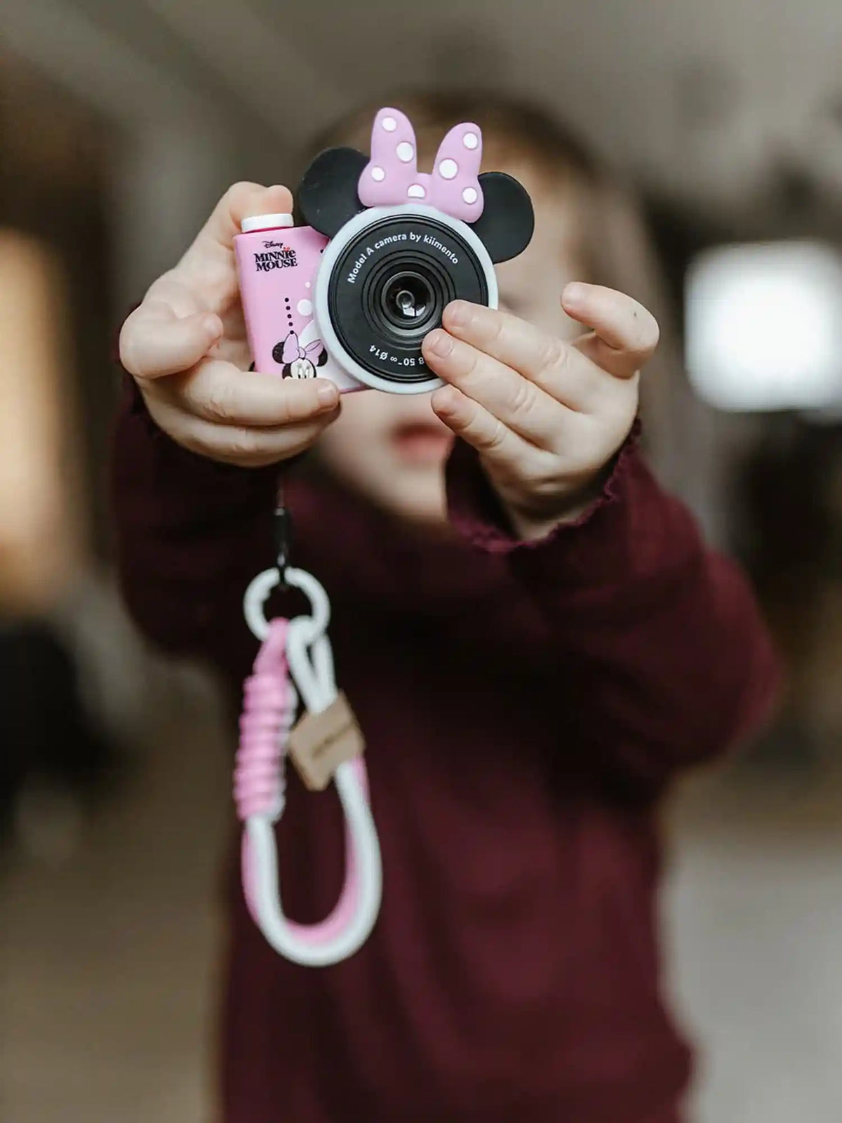 Girl holding kiimento Disney Minnie Mouse Mini Camera Model A – pink Minnie Mouse mini camera for kids