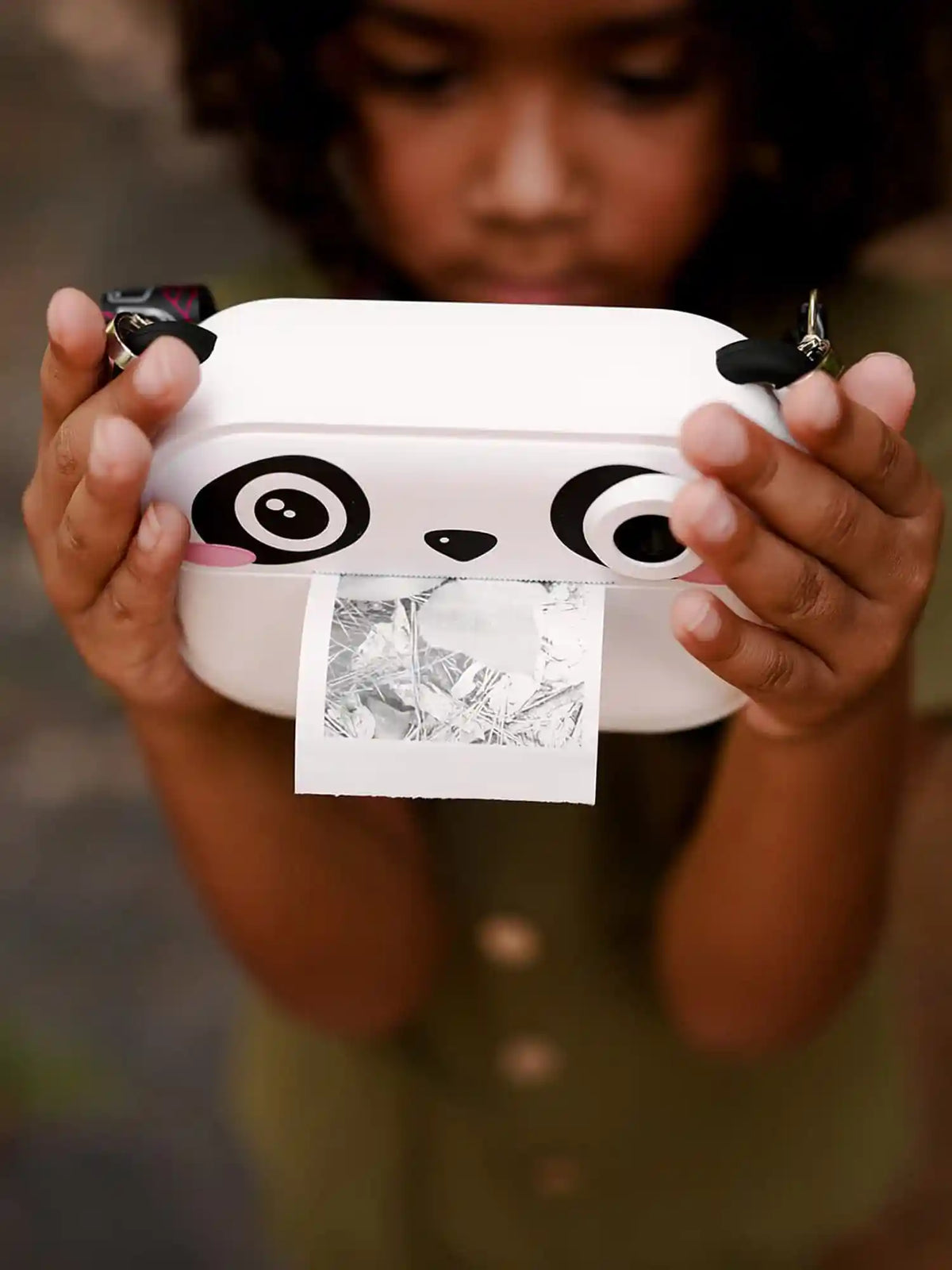Child holding kiimento Panda Print Camera Model P printing a photo outdoors – kids instant print camera