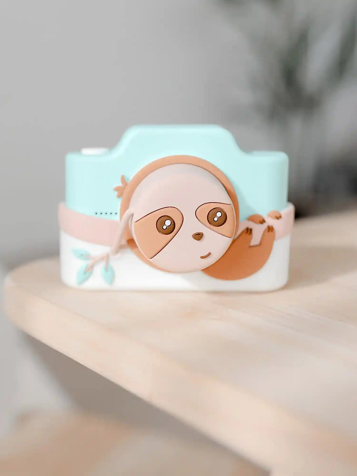 kiimento Sloth Digital Camera Model K displayed on a wooden table – cute teal kids camera for ages 5 to 8