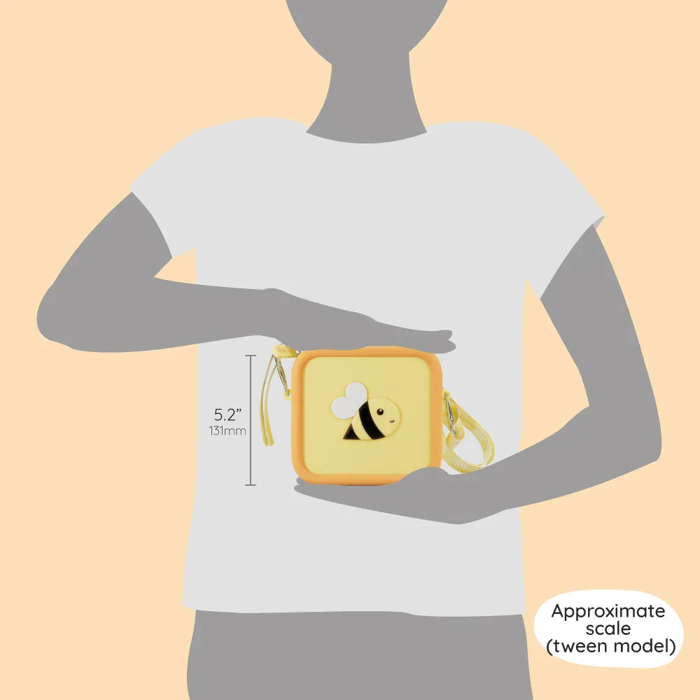 A small yellow silicone bee bag with an adjustable strap shown for scale against a person.